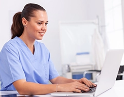 DC Medical Institute - Medical nurse in uniform with laptop